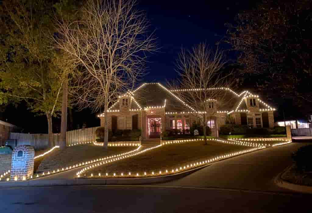 Home and front walkway outlined with warm lights at night