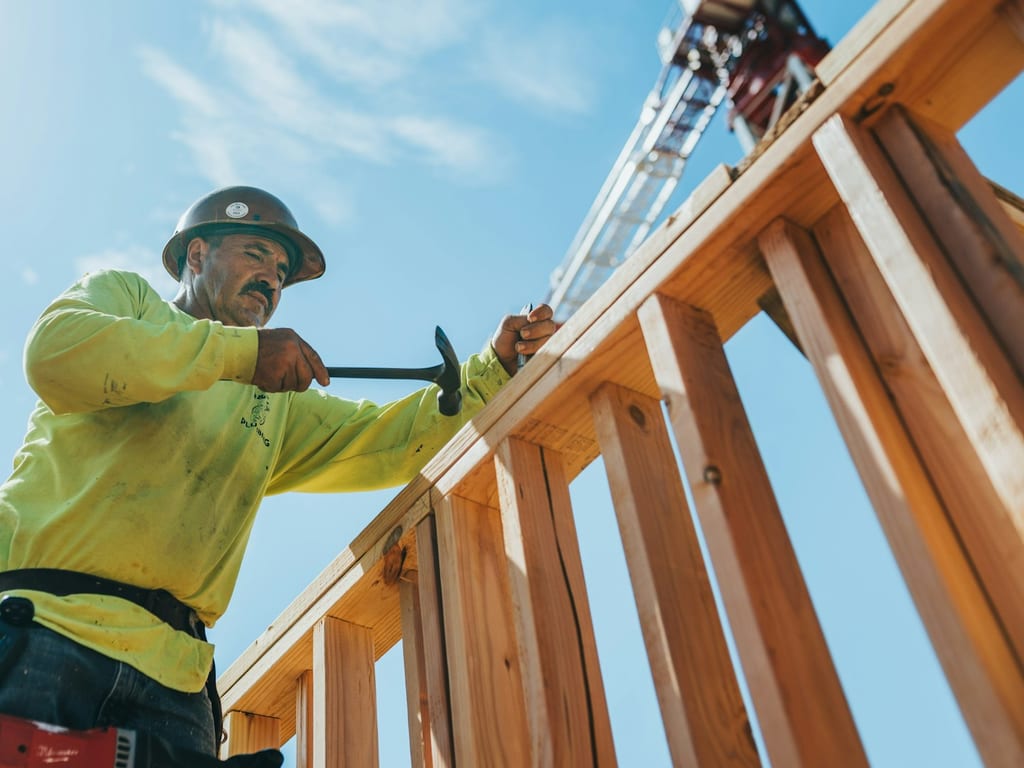 Construction worker building a wooden frame
